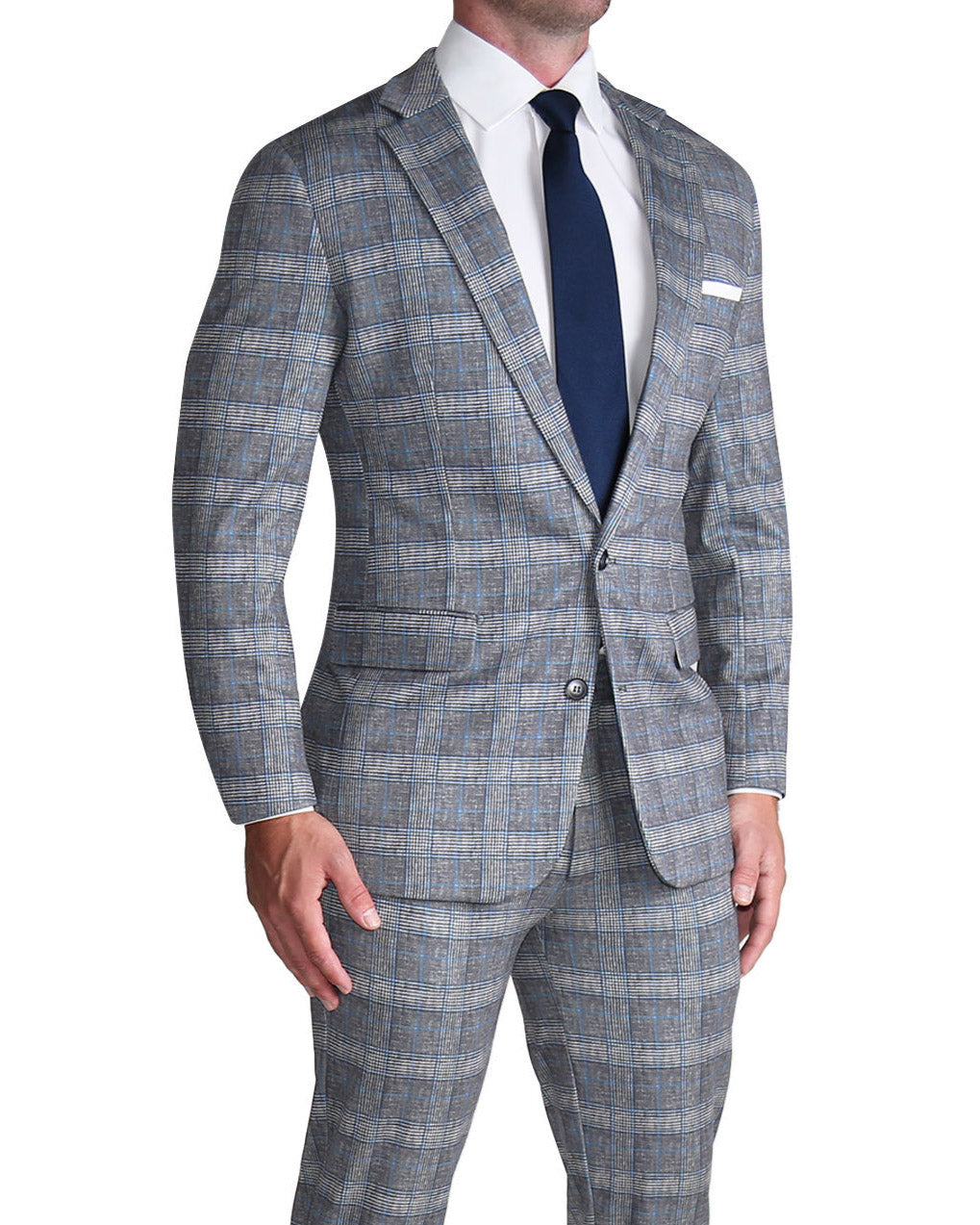 A man wearing a grey with blue plaid stretch suit, featuring a two-button blazer with medium notch lapels and a double vent jacket, paired with a white dress shirt and a dark blue tie.