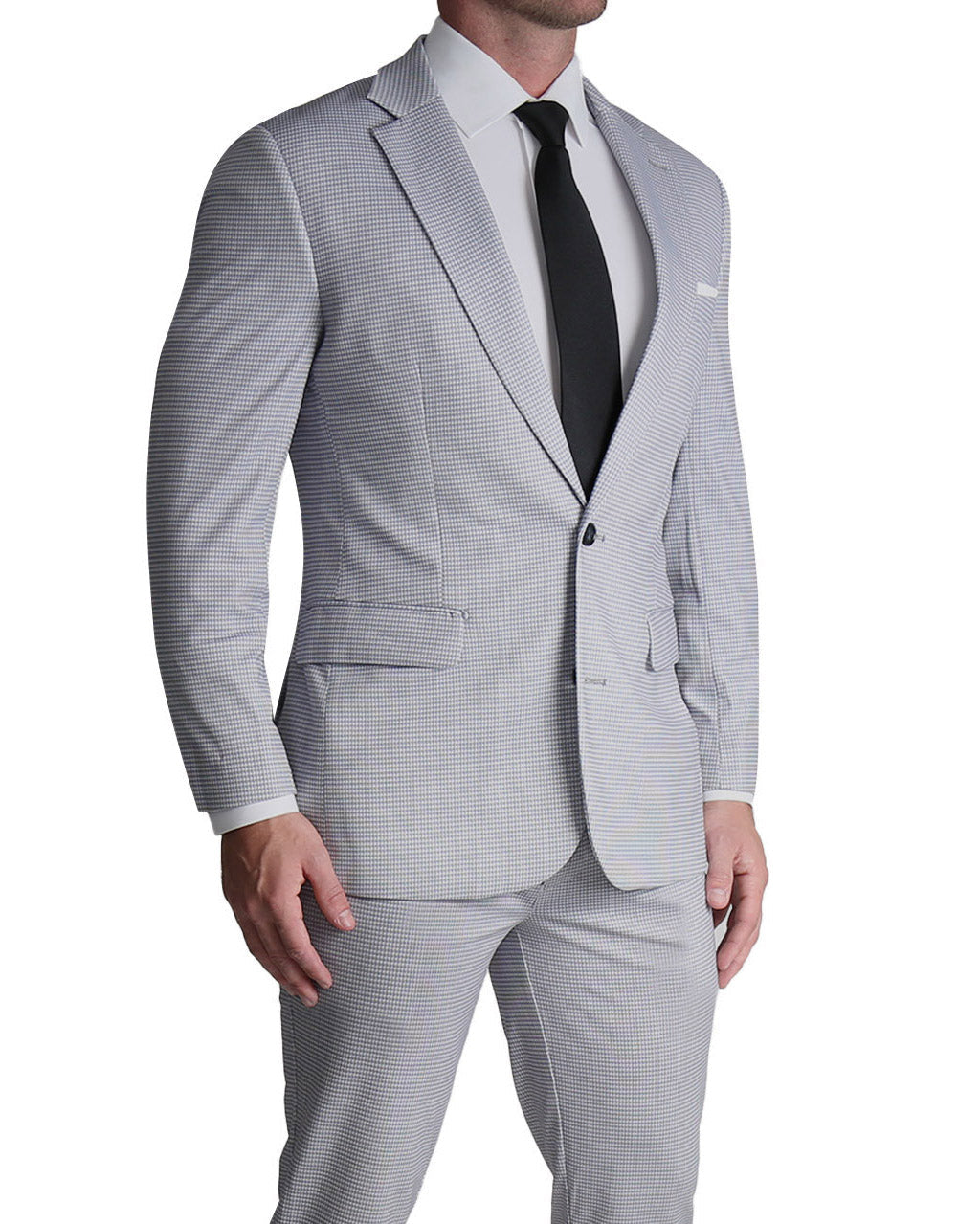 A man wearing a grey houndstooth microcheck athletic fit stretch suit with a white dress shirt and a dark tie.