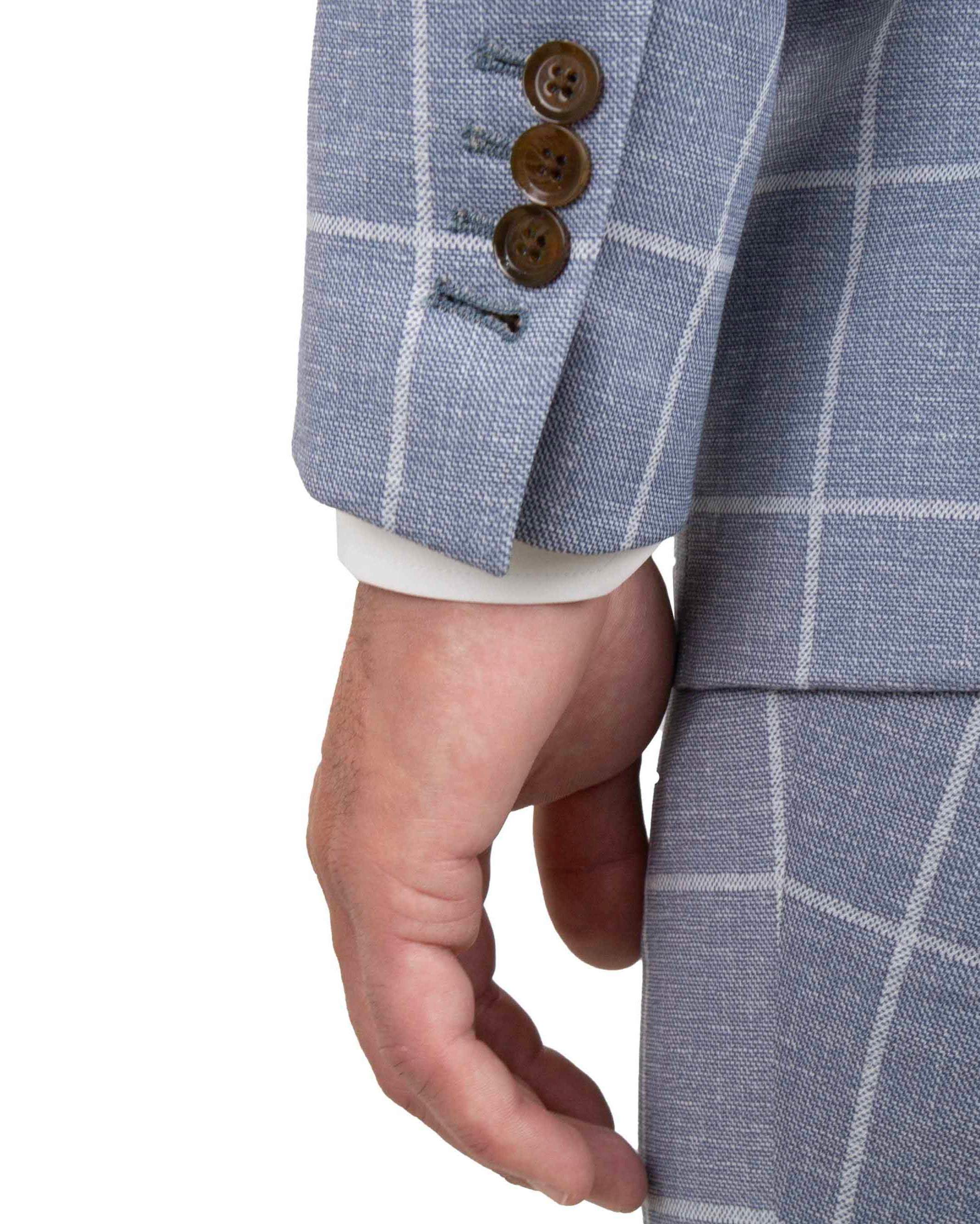 Close-up of a blue checkered suit jacket with brown buttons on a white background