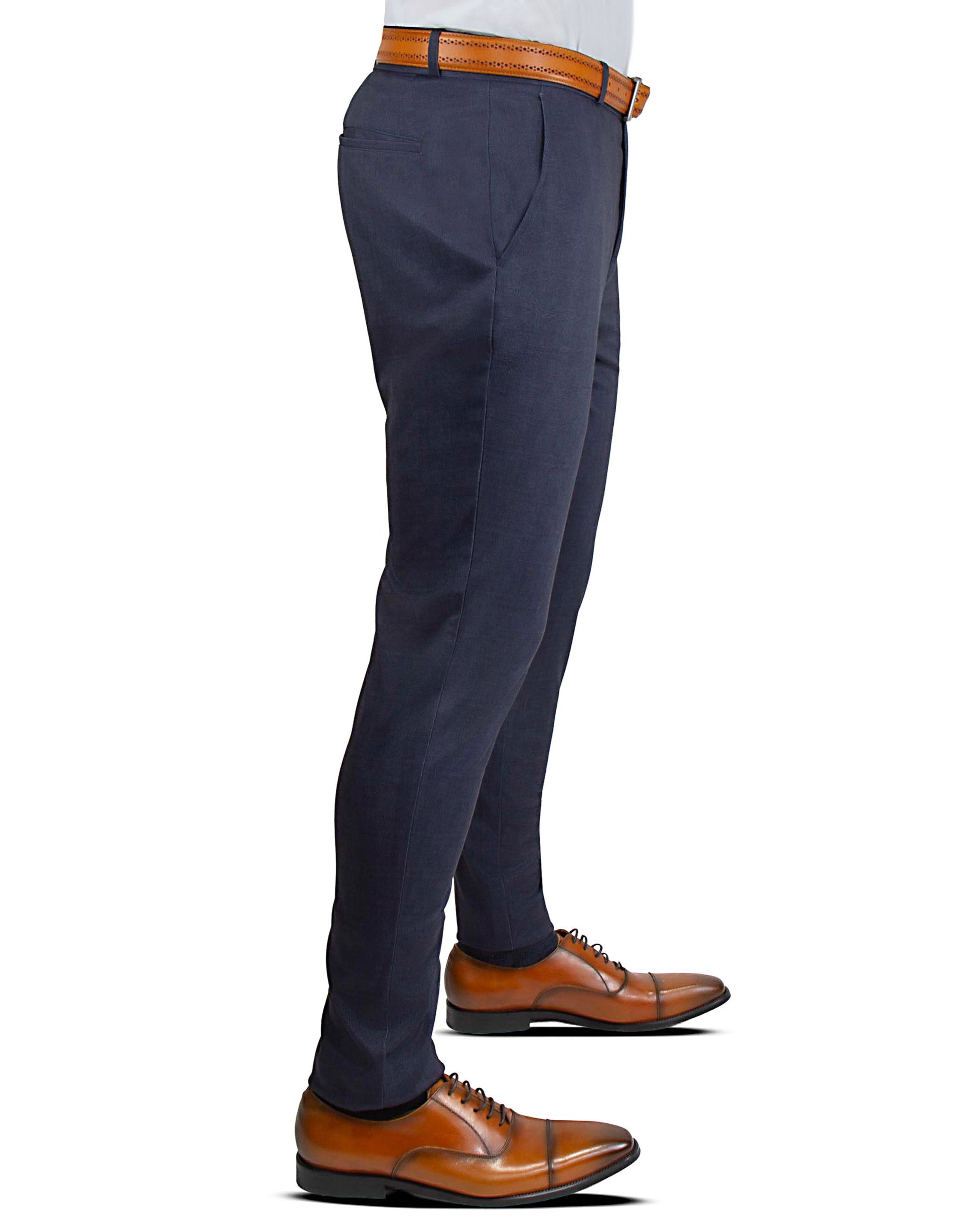 Navy blue dress pants with brown shoes on a white background