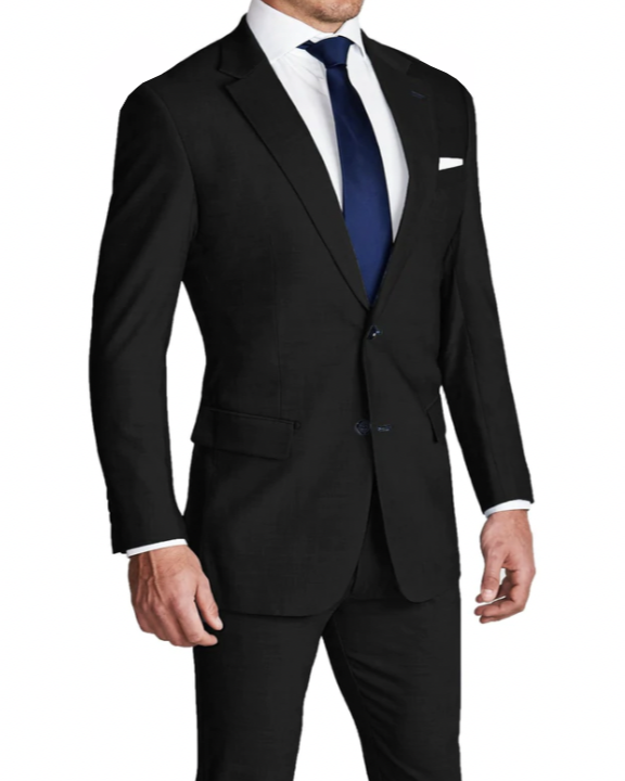 A man wearing a heathered black stretch suit with a white shirt and a blue tie.