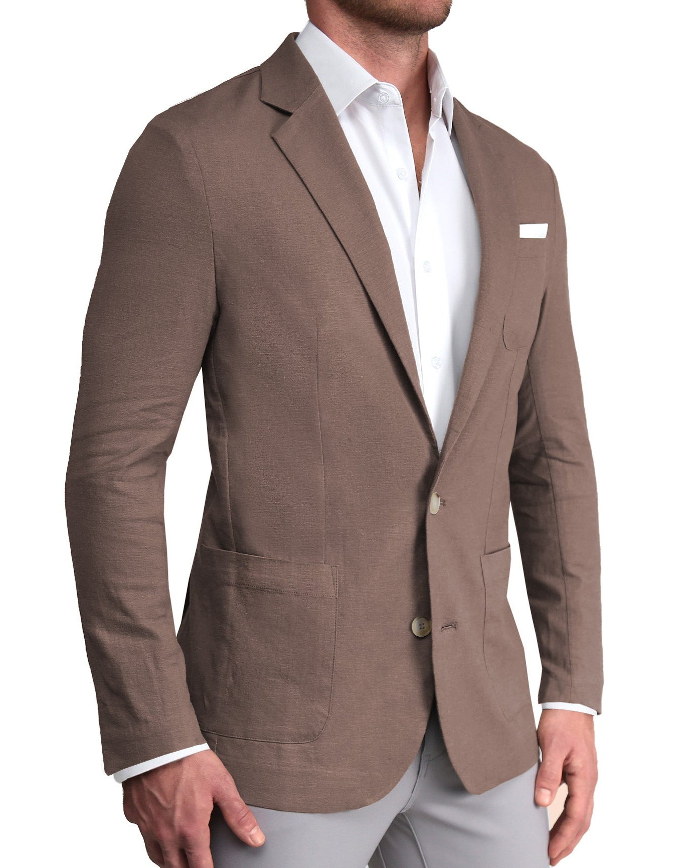 A man wearing a taupe unstructured linen blazer with patch pockets, a white shirt, and light gray trousers.